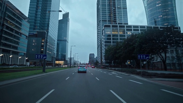 Video Reference N3: Skyscraper, Building, Sky, Daytime, Vehicle, Car, Infrastructure, Road surface, Cloud, Asphalt
