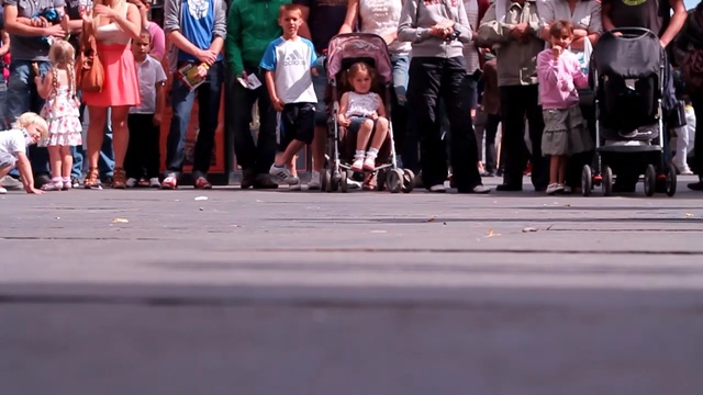 Video Reference N1: road, street, crowd, infrastructure, pedestrian, vehicle, recreation, race, car, public event, Person