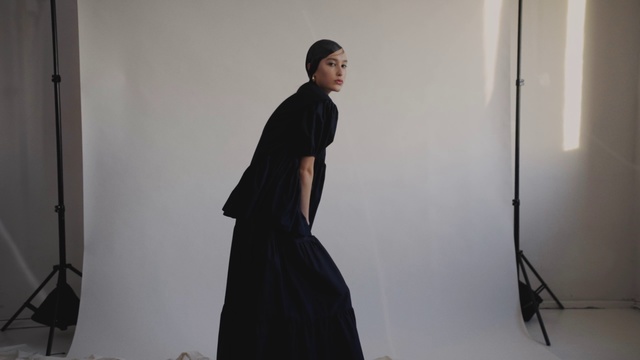 Video Reference N1: Standing, Outerwear, Fashion, Dress, Shoulder, Costume, Room, Abaya, Photography, Fashion design