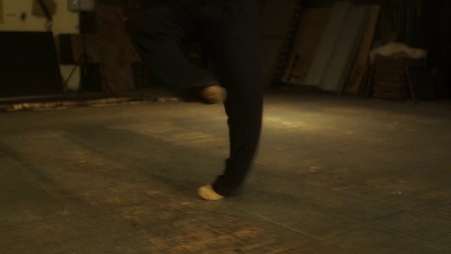 Video Reference N10: Black, Floor, Leg, Night, Darkness, Flooring, Dance, Footwear, Human body, Hardwood, Person, Man, Woman, Holding, White, Standing, Walking, Street, Young, Riding, Playing, Room, Cat, Umbrella, Ball, Doing, Trousers, Clothing