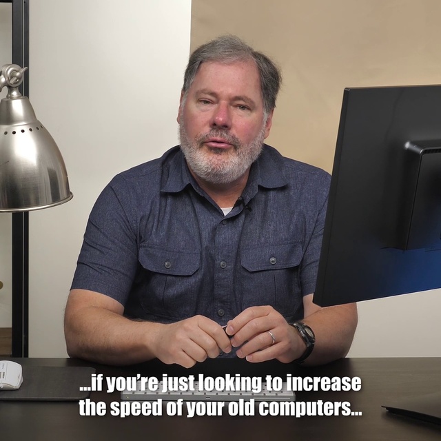 Video Reference N3: Arm, Facial hair, Muscle, Photography, Job, Electronic device, Finger, Sconce, Photo caption, Person, Man, Indoor, Table, Sitting, Computer, Holding, Front, Black, Desk, Photo, Laptop, Posing, Smiling, Woman, Large, Keyboard, Cake, Sign, Standing, White, Wall, Text, Clothing, Human face, Shirt, Screenshot