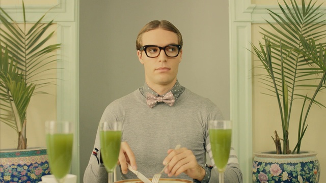 Video Reference N2: green, glasses, vision care, plant, furniture, eyewear, facial hair, table, interior design, glass, Person
