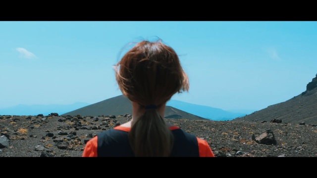 Video Reference N3: sky, blue, mountainous landforms, photograph, rock, wilderness, mountain, girl, horizon, vacation