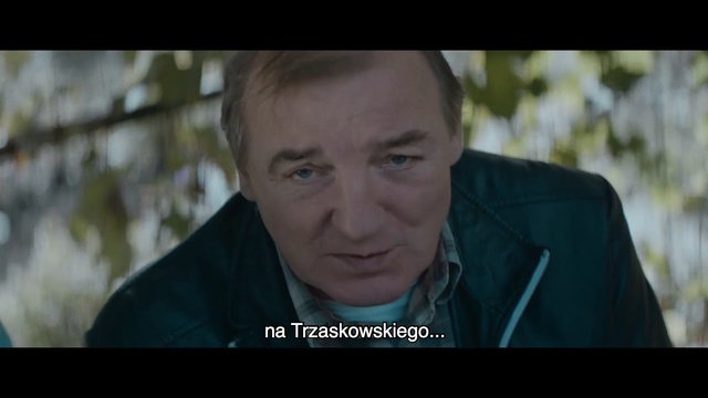 Video Reference N1: Movie, Screenshot, Photo caption, Photography, Adaptation, Smile, Person, Man, Indoor, Screen, Laptop, Sitting, Looking, Holding, Photo, Front, Computer, Using, Monitor, Black, Table, Television, Smiling, Apple, Phone, Wearing, Shirt, Young, White, Human face, Text, Face, Portrait, Forehead, Male