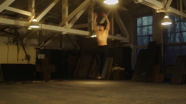 Video Reference N15: Attic, Room, Floor, Flooring, Performance art, Ceiling, Building, Indoor, Man, Air, Front, Large, Sitting, Table, Woman, Standing, Jumping, Plane, Old, Display, White, Young, Doing, Luggage, Trick, Fire, Riding, Bed, Airplane, Dance, Person, Clothing