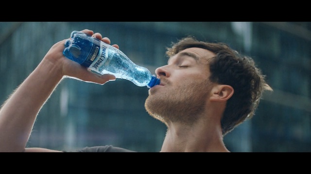 Video Reference N1: Water, Drinking water, Drink, Pocari sweat, Drinking, Soft drink, Mineral water, Water bottle, Carbonated soft drinks, Bottled water, Person, Man, Racket, Holding, Looking, Player, Standing, Woman, Game, Ball, Playing, Female, Young, Close, Wearing, Glass, Court, Swinging, Video, Food, Red, White, Bottle, Swimming, Male