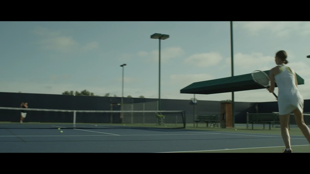 Video Reference N11: tennis, tennis court, sky, mode of transport, racquet sport, sport venue, net, structure, player, sports