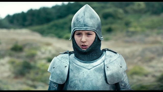 Video Reference N1: Helmet, Armour, Knight, Personal protective equipment, Headgear, Screenshot, Middle ages, Smile, Outdoor, Person, Clothing, Grass, Man, Wearing, Uniform, Holding, Field, Standing, Mountain, Hat, Small, Young, Boy, Carrying, Military, Green, Little, Riding, Walking, White, Woman, Board, Large, Red, Horse, Blue, Street, Bear, Kite, Human face, Jacket, Armor