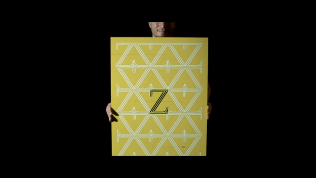 Video Reference N3: yellow, text, font, symmetry, pattern, square, rectangle, angle, gold, computer wallpaper, Person