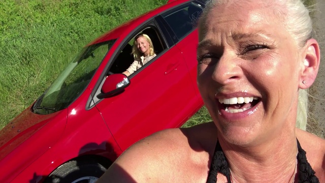 Video Reference N2: Facial expression, Vehicle, Car, Smile, Blond, Vehicle door, Photography, Compact car, Selfie, Laugh, Person, Grass, Outdoor, Man, Smiling, Wearing, Red, Looking, Front, Camera, Posing, Glasses, Black, Head, Face, Dog, Holding, Driving, Truck, Standing, Hot, Large, Close, Woman, Talking, Hat, White, Riding, Phone, Bus, Field, Hotdog, Human face, Land vehicle, Clothing