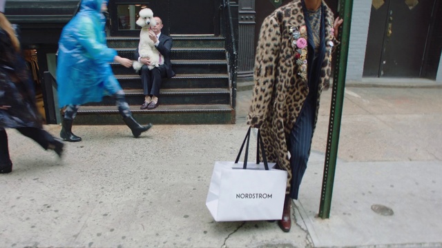 Video Reference N0: Street fashion, Fashion, Fur, Style, Person, Building, Woman, Walking, Man, Suitcase, Luggage, Front, Sitting, Bag, Holding, Room, Standing, Street, Sidewalk, People, Table, Girl, Young, Living, Playing, Suit, City, Umbrella, Group, Cat, Phone, Dog, White, Doing, Laying, Sign, Ball, Clothing, Footwear, Floor, Jeans, Trousers, Handbag, Luggage and bags, Fashion accessory