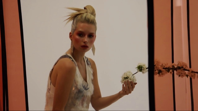 Video Reference N6: Hair, Shoulder, Hairstyle, Arm, Joint, Blond, Bun, Floral design, Plant, Long hair, Person