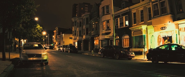 Video Reference N1: night, town, car, yellow, street, neighbourhood, urban area, city, light, road, Person