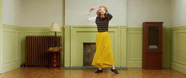 Video Reference N4: clothing, yellow, dress, standing, room, shoulder, floor, flooring, joint, girl