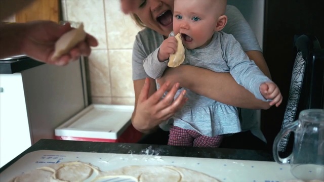 Video Reference N2: Child, Food, Mongolian food, Toddler, Dish, Baking, Cuisine, Comfort food, Person, Indoor, Table, Sitting, Baby, Front, Little, Small, Holding, Eating, Plate, Kitchen, Young, High, Large, Cake, Pizza, Mouth, Human face, Boy