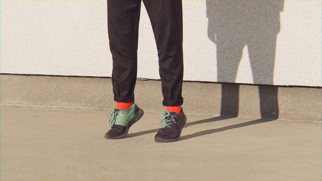 Video Reference N4: Footwear, Shoe, Jeans, Leg, Standing, Human leg, Fashion, Ankle, Joint, Street fashion, Person, Building, Man, Suit, Holding, Wearing, Front, Young, Ball, Black, Court, Street, Riding, Talking, Walking, Phone, Woman, Playing, Red, Board, White, Blue, Trousers, Ground, Boot, Clothing, High heels, Sandal, Feet, Denim, Pocket, Knee, Sock, Sneakers, Waist, Casual dress, Trouser