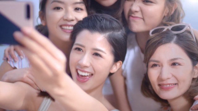 Video Reference N1: Skin, Facial expression, Selfie, Friendship, Smile, Fun, Youth, V sign, Photography, Happy, Person, Indoor, Young, Girl, Group, Woman, Posing, People, Sitting, Standing, Photo, Child, Table, Man, Holding, Smiling, Little, Cake, Talking, Room, Phone, White, Human face, Clothing, Bride, Wedding dress