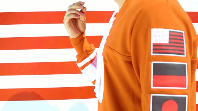 Video Reference N0: t shirt, orange, sleeve, outerwear, product, shoulder, flag, product, sportswear, jersey
