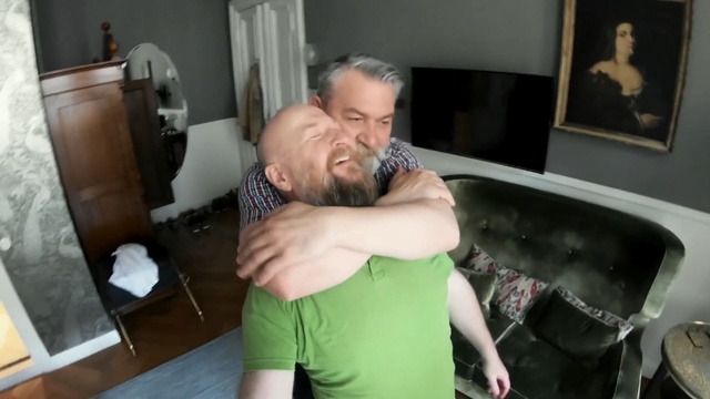 Video Reference N0: Shoulder, Arm, Joint, Muscle, Interaction, Hug, Leg, Fun, Room, Neck, Person, Indoor, Man, Holding, Young, Standing, Shirt, Living, Front, Boy, Kitchen, Woman, Wearing, Playing, Food, Table, Green, Remote, Video, Pizza, Wall, Human face, Kiss