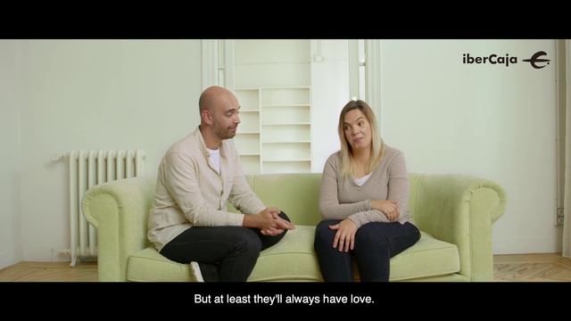 Video Reference N0: Photograph, Sitting, Conversation, Blond, Photo caption, Room, Couch, Photography, Happy, Furniture, Person, Indoor, Woman, Window, Looking, Man, Holding, Table, Front, Using, Black, Laptop, Standing, Computer, Young, Phone, Suit, White, People, Clothing, Wall, Human face, Smile, Text, Screenshot