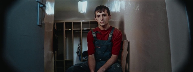 Video Reference N4: Standing, Shoulder, Arm, Male, Snapshot, Human, Eye, Muscle, Human body, Room, Person, Indoor, Man, Young, Kitchen, Boy, Window, Front, Shirt, Holding, Refrigerator, Smiling, Black, Wearing, Door, Table, Oven, Pizza, White, Stove, Wall, Human face, Clothing