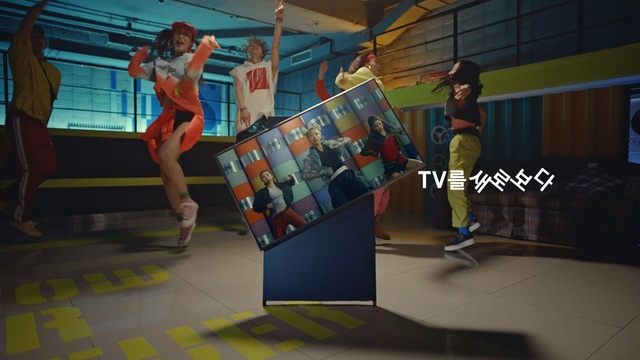 Video Reference N0: Room, Animation, Recreation, Floor, Indoor, Woman, Girl, Sitting, Looking, Table, Young, Standing, Holding, Playing, Court, Walking, Female, Computer, Man, Living, People, Group, Video, Doing, Stuffed, Person, Clothing, Footwear, Cartoon, Dance, Physical fitness, Screenshot