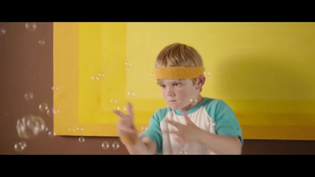 Video Reference N1: yellow, green, child, boy, sitting, standing, toddler, fun, snapshot, photography, Person