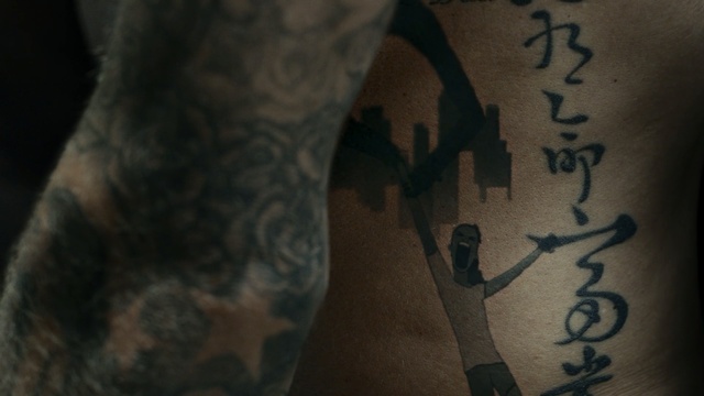 Video Reference N0: tattoo, arm, hand, back, tree, tattoo artist, human leg, darkness, joint, chest, Person