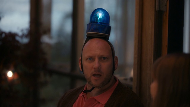Video Reference N3: Human, Headgear, Temple, Screenshot, Vacation, Person, Man, Wearing, Looking, Standing, Holding, Front, Hat, Sitting, Shirt, Table, Food, Cake, Young, Red, Pizza, White, Blue, Street, Phone, Human face, Clothing