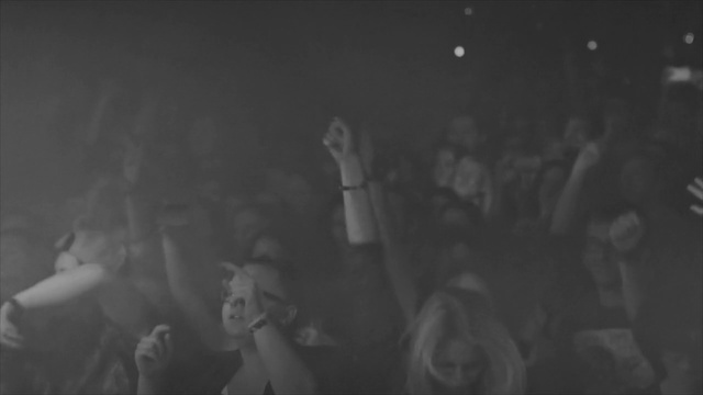 Video Reference N1: Black, White, Photograph, Monochrome, Black-and-white, Monochrome photography, Snapshot, Crowd, Fun, Photography, Photo, Man, Standing, Dark, Woman, People, Holding, Horse, Riding, Young, Walking, Old, Group, Street, Game, Human face, Person, Concert, Text, Dance, Black and white