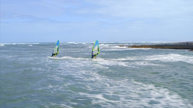 Video Reference N0: Windsurfing, Surface water sports, Wave, Wind wave, Boardsport, Recreation, Wind, Water sport, Outdoor recreation, Surfing equipment, Outdoor, Water, Kite, Surfing, Sport, Ocean, Board, Man, Holding, Young, Green, Standing, Riding, Little, Body, Girl, Flying, Beach, Large, Boat, People, Sky, Surfboard, Sports equipment, Surf, Windsports, Day