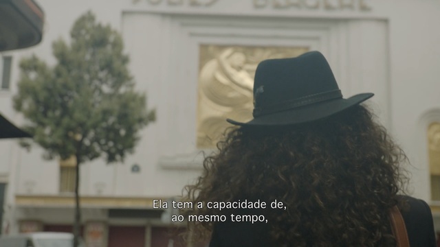 Video Reference N3: Hair, Headgear, Tree, Temple, Long hair, Hat, Photography, Fashion accessory, Fedora, Window, Person