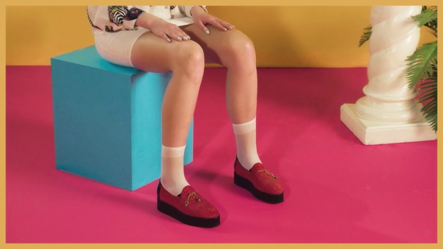 Video Reference N5: Human leg, Leg, Footwear, Shoe, Pink, Thigh, High heels, Joint, Ankle, Human body, Indoor, Table, Sitting, Woman, Girl, Front, Green, Holding, Standing, Young, Yellow, Red, Television, Desk, Playing, White, Room, Blue, Train, Phone, Floor, Legs, Sandal