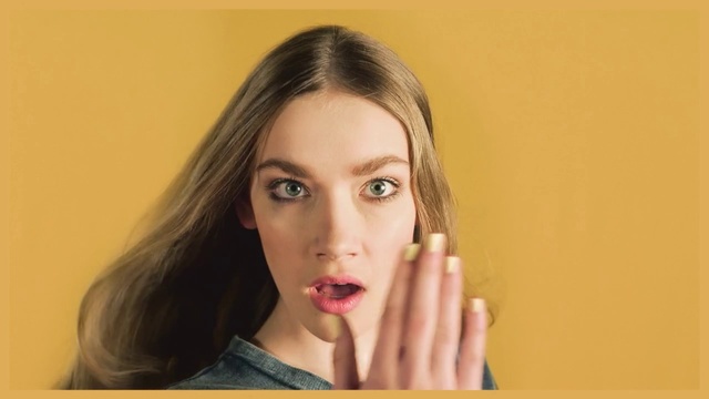 Video Reference N0: Face, Lip, Hair, Skin, Nose, Eyebrow, Cheek, Forehead, Head, Chin, Person, Indoor, Woman, Young, Yellow, Girl, Holding, Lady, Shirt, Mouth, Smiling, Food, White, Wearing, Standing, Room, Teeth, Brushing, Wall, Human face, Lipstick, Portrait, Eyes, Cosmetics, Eyelash, Nail, Tooth