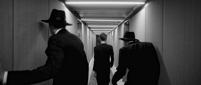 Video Reference N1: Black, Black-and-white, Standing, Monochrome, Film noir, Monochrome photography, Photography, Headgear, Suit, Movie