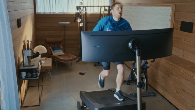 Video Reference N1: Desk, Standing, Exercise machine, Exercise equipment, Furniture, Room, Treadmill, Table, Sitting