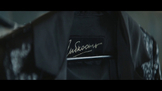 Video Reference N1: Black, Clothing, Jacket, T-shirt, Leather, Darkness, Sleeve, Font, Textile, Automotive design