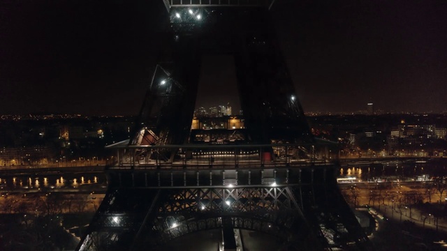 Video Reference N1: Night, Landmark, Architecture, Metropolitan area, City, Tower, Metropolis, Sky, Cityscape, Midnight, Building, Train, Bridge, Track, Large, Light, Lit, Sitting, Snow, View, Table, Water, Traveling, Platform, Station, White, Display, Standing, Plane, Riding, Clock, River, Skyscraper, Moon, Arch