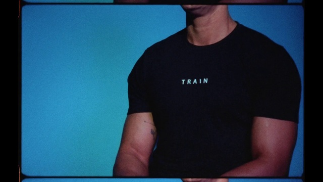 Video Reference N8: T-shirt, Blue, Arm, Shoulder, Neck, Top, Font, Chest, Muscle, Hand