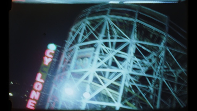 Video Reference N1: ferris wheel, tourist attraction, light, structure, night, daylighting, recreation, space, darkness, world