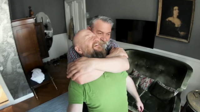 Video Reference N0: Shoulder, Arm, Joint, Muscle, Hug, Interaction, Leg, Fun, Room, Neck, Person, Indoor, Man, Holding, Young, Standing, Shirt, Living, Front, Boy, Sitting, Playing, Woman, Using, Kitchen, Food, Table, Wearing, Green, Remote, Video, Pizza, Wall, Human face, Kiss