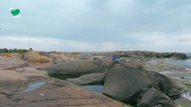 Video Reference N2: Rock, Boulder, Ecoregion, Formation, Geology, Sea, Landscape, Badlands, Coast, Geological phenomenon, Outdoor, Mountain, Standing, Rocky, Sitting, Small, Green, Man, Large, Water, Walking, Ocean, Field, Flying, Bird, People, Beach, Sky, Cloud, Lake, Nature