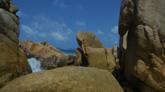 Video Reference N8: rock, boulder, sky, formation, bedrock, outcrop, terrain, cliff, geology, mountain, Person