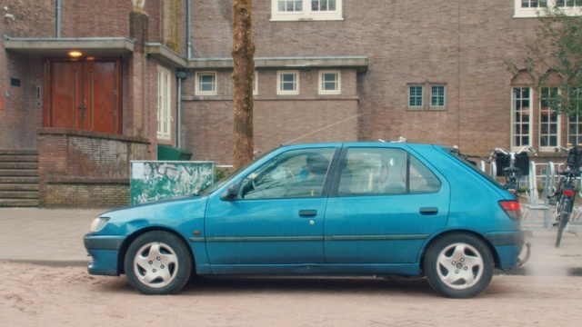 Video Reference N0: car, land vehicle, vehicle, family car, vehicle door, peugeot, hatchback, city car, peugeot 306, road, Person