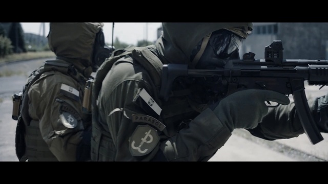 Video Reference N3: Military, Soldier, Personal protective equipment, Firearm, Gun, Automotive wheel system, Automotive tire, Troop, Photography, Army, Thing, Weapon, Photo, Man, White, Street, Covered, Holding, Standing, Mirror, Riding, Room, Bed, Motorcycle, Group, Snow, Parked, People, Laying, Screenshot, Clothing, Jacket, Car, Person, Helmet