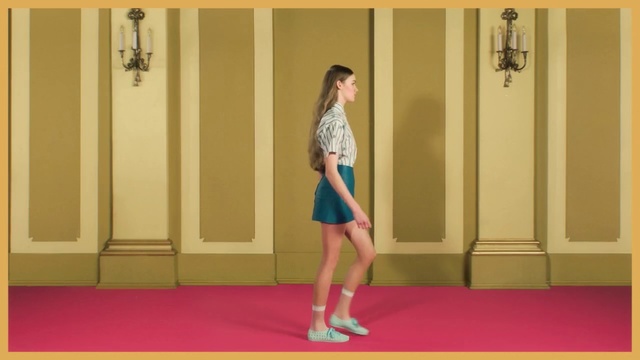 Video Reference N2: Shoulder, Leg, Joint, Yellow, Arm, Standing, Flooring, Snapshot, Carpet, Human leg, Indoor, Woman, Girl, Young, Building, Front, Holding, Red, Playing, Door, Rug, Frisbee, Room, Man, White, Floor, Wall, Footwear, Dress, Skirt, Clothing, High heels, Miniskirt, Knee