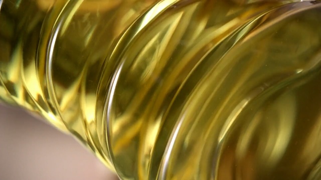 Video Reference N8: Yellow, Vegetable oil, Close-up, Soybean oil, Cooking oil, Metal, Brass, Glass, Transparent material