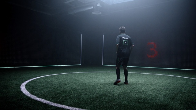 Video Reference N8: black, green, sport venue, football, player, atmosphere, structure, light, ball, photography, Person