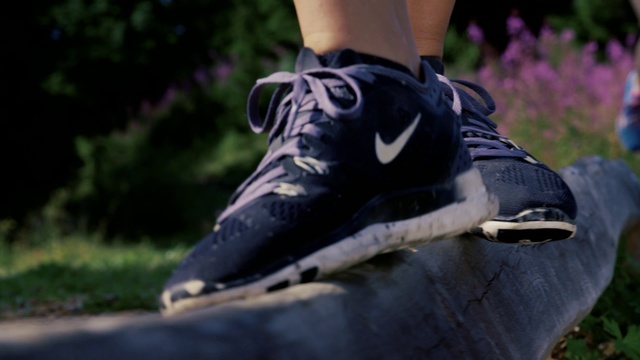 Video Reference N11: Footwear, Shoe, Black, Purple, Sneakers, Grass, Athletic shoe, Outdoor shoe, Tree, Jeans, Person, Outdoor, Riding, Man, Wearing, Baseball, Standing, Ball, Young, Player, Field, Board, Street, Helmet, Holding, Swinging, Playing, White, Doing, Trick, Game, Bat, Air, Walking shoe, Skateboard, Boot, Sandal, Skate shoe