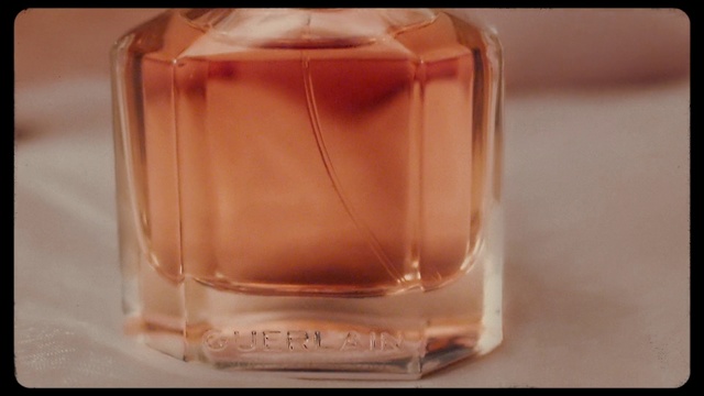 Video Reference N2: Glass bottle, Peach, Perfume, Caramel color, Fluid, Drink, Liquid, Glass, Drinkware, Bottle